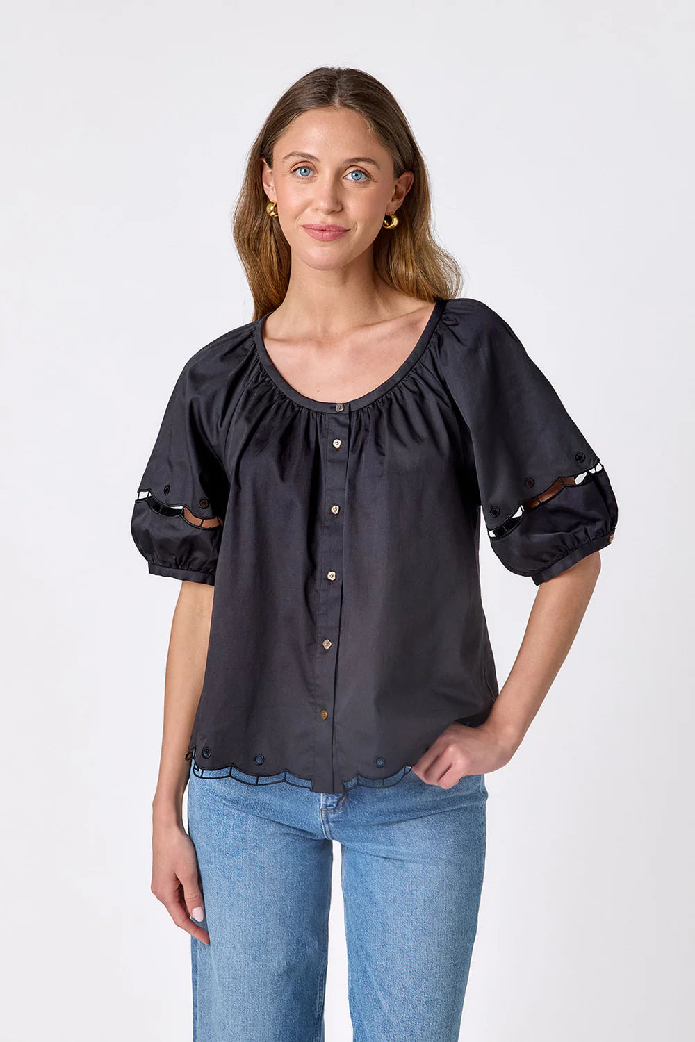 Crosby Perrie Top in black, styled with a gathered scoop neckline, balloon sleeves, and button front, worn with medium-wash denim.
