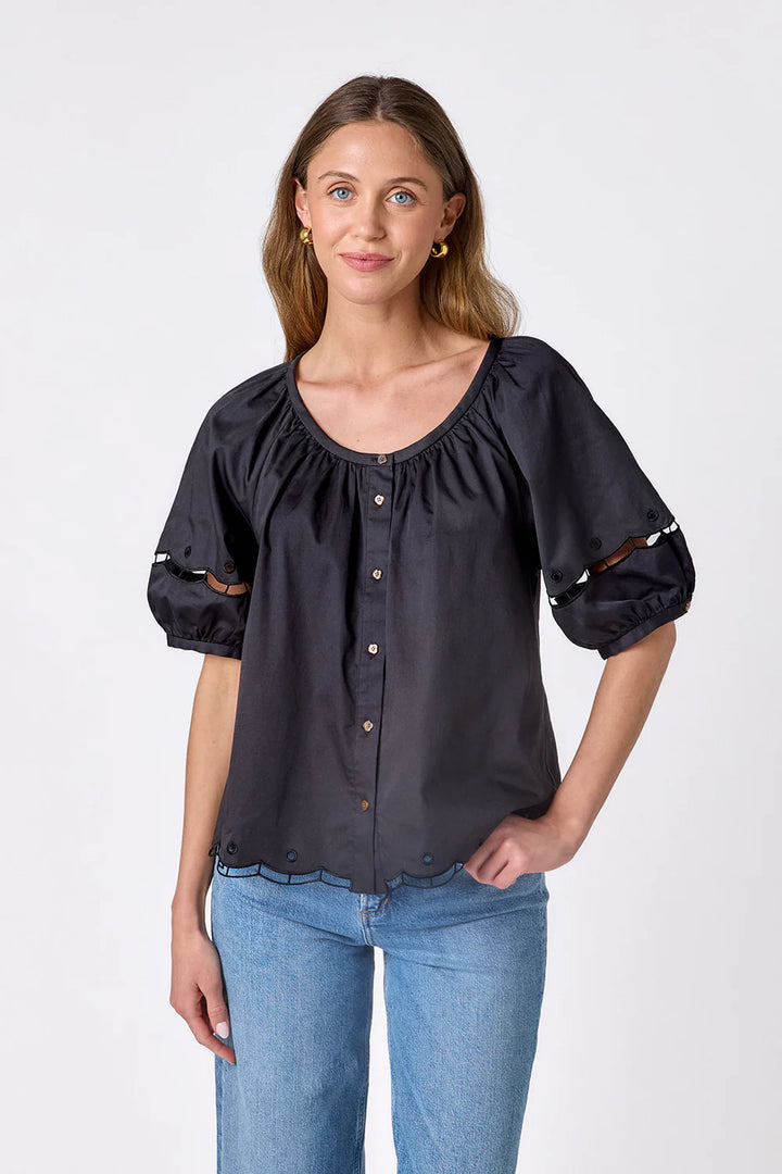 Crosby Perrie Top in black, styled with a gathered scoop neckline, balloon sleeves, and button front, worn with medium-wash denim.