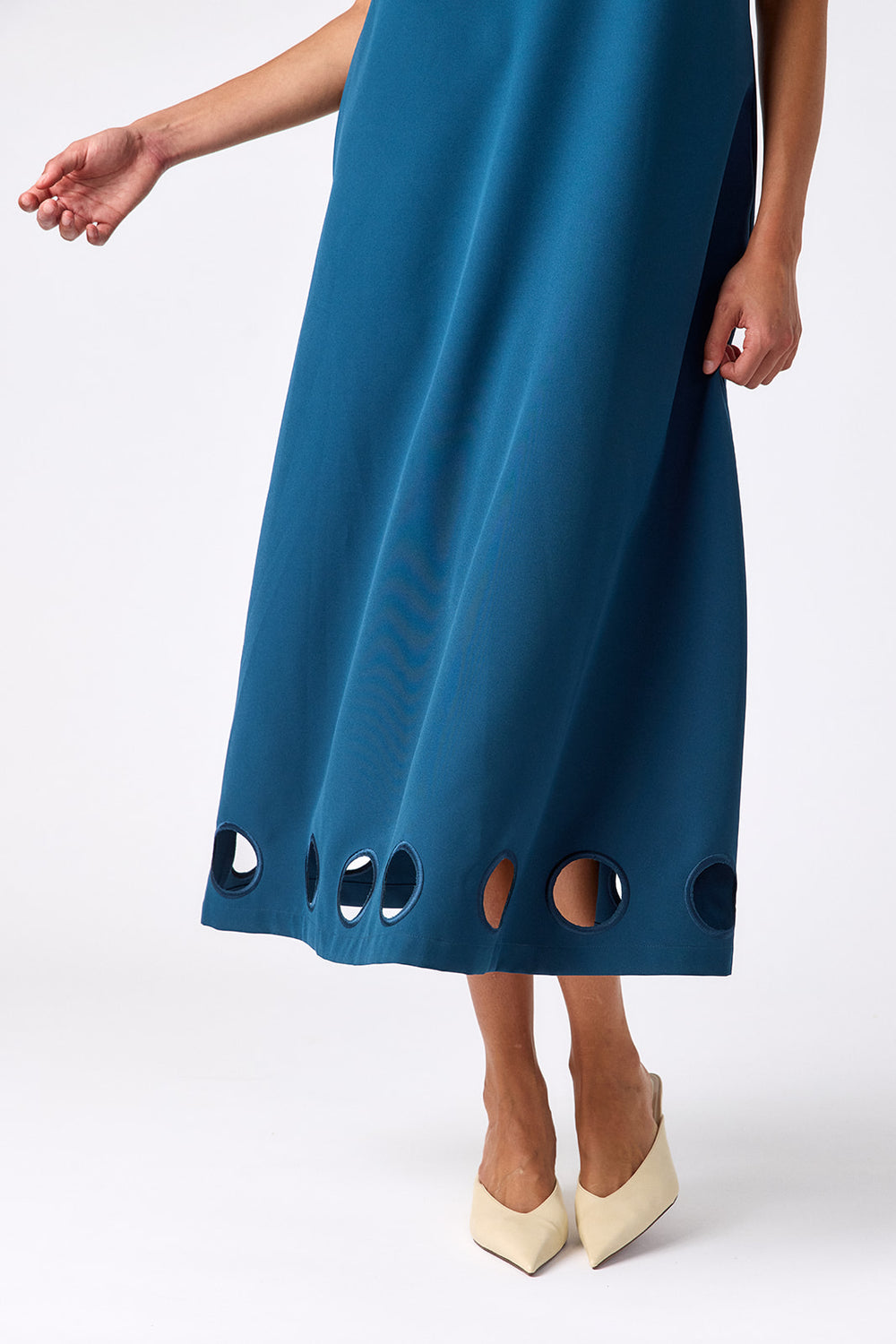 Crosby Coco Dress in Midnight — detail view of alternating circular cutouts along the hem