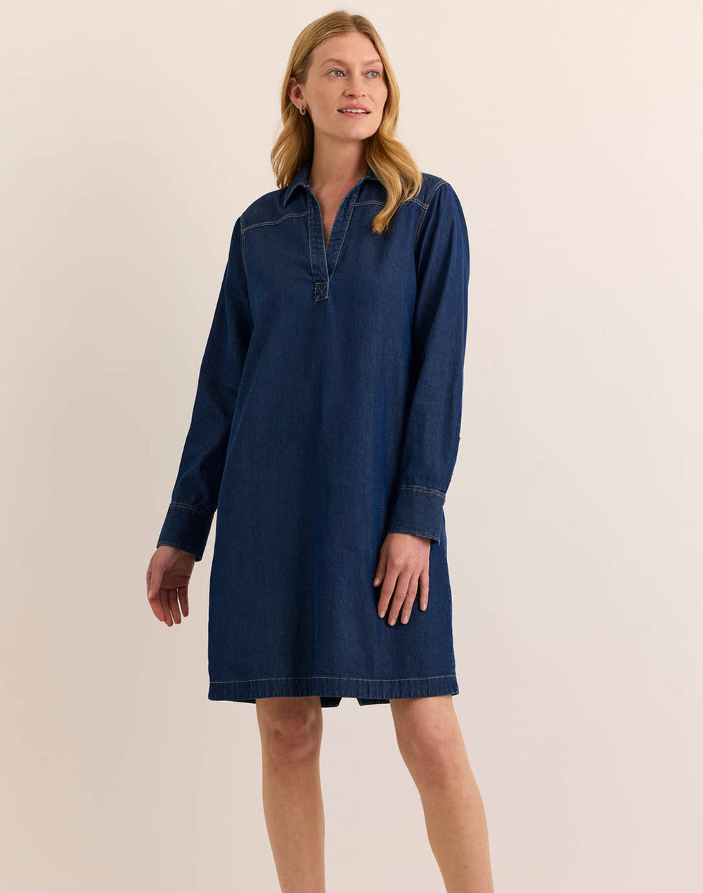 Close-up of Hinson Wu Monica Dress cuff and gold button hardware, showing the Tencel-cotton denim texture and stitching detail.