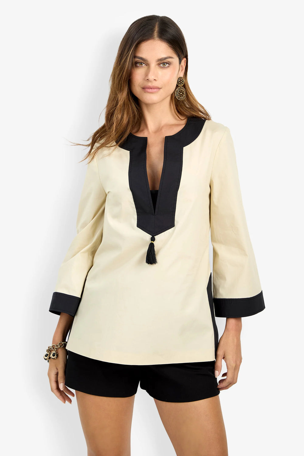 Trina Turk Dametria Top in ivory and black colorblock, close front view, split neckline with tassel tie and contrast trim detail.