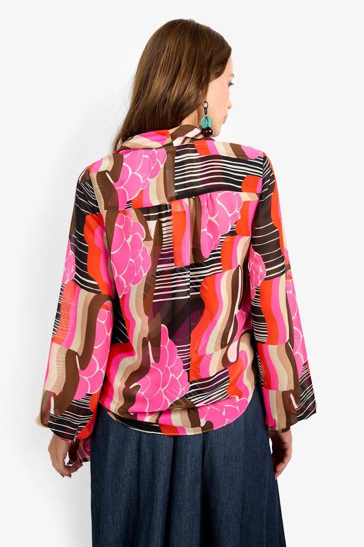 Trina Turk Pienza Top in pink, brown, and orange abstract print, back view, showing gathered yoke and sleeve fullness.