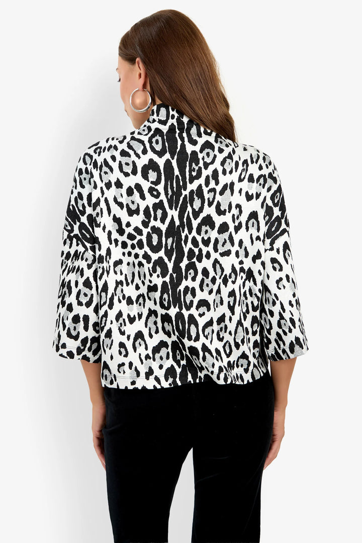 Back view of the Trina Turk Sidony Top in black-and-white leopard print showing the funnel neckline, relaxed fit, and elbow-length sleeves.