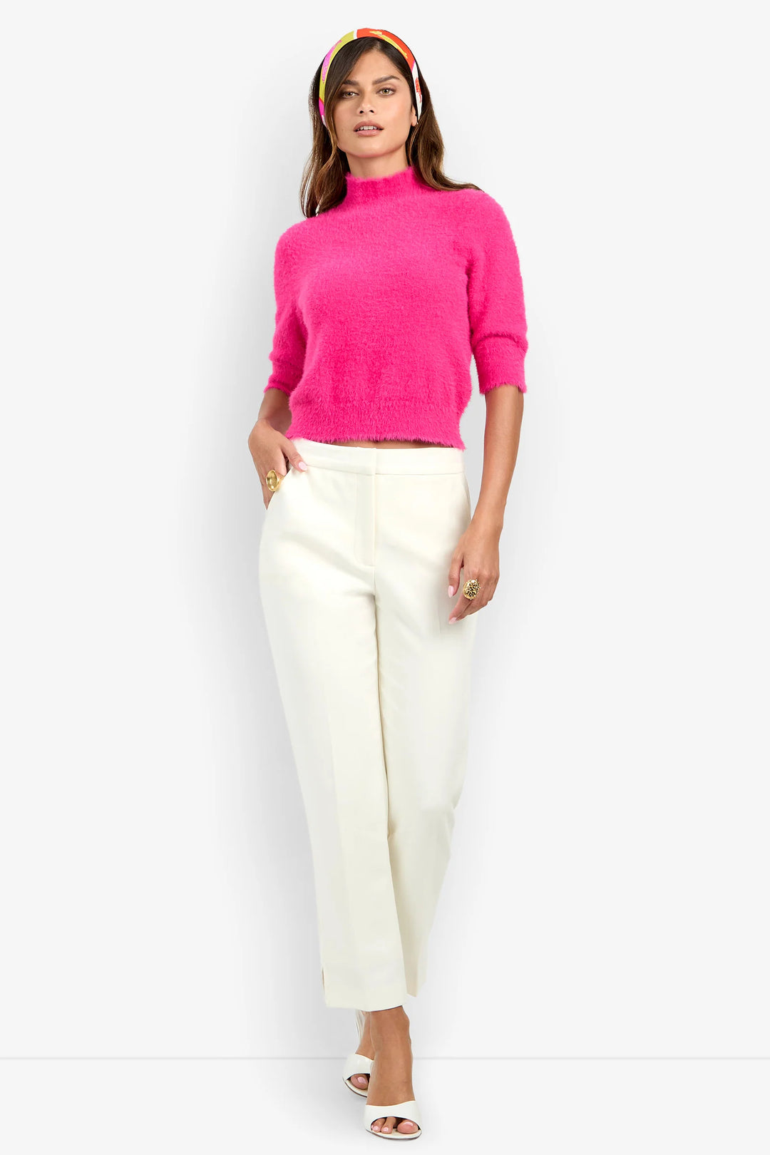 Model wearing the Trina Turk Arno 2 Pant in winter white with a slim ankle-length leg, tailored waistband, and pressed center creases.