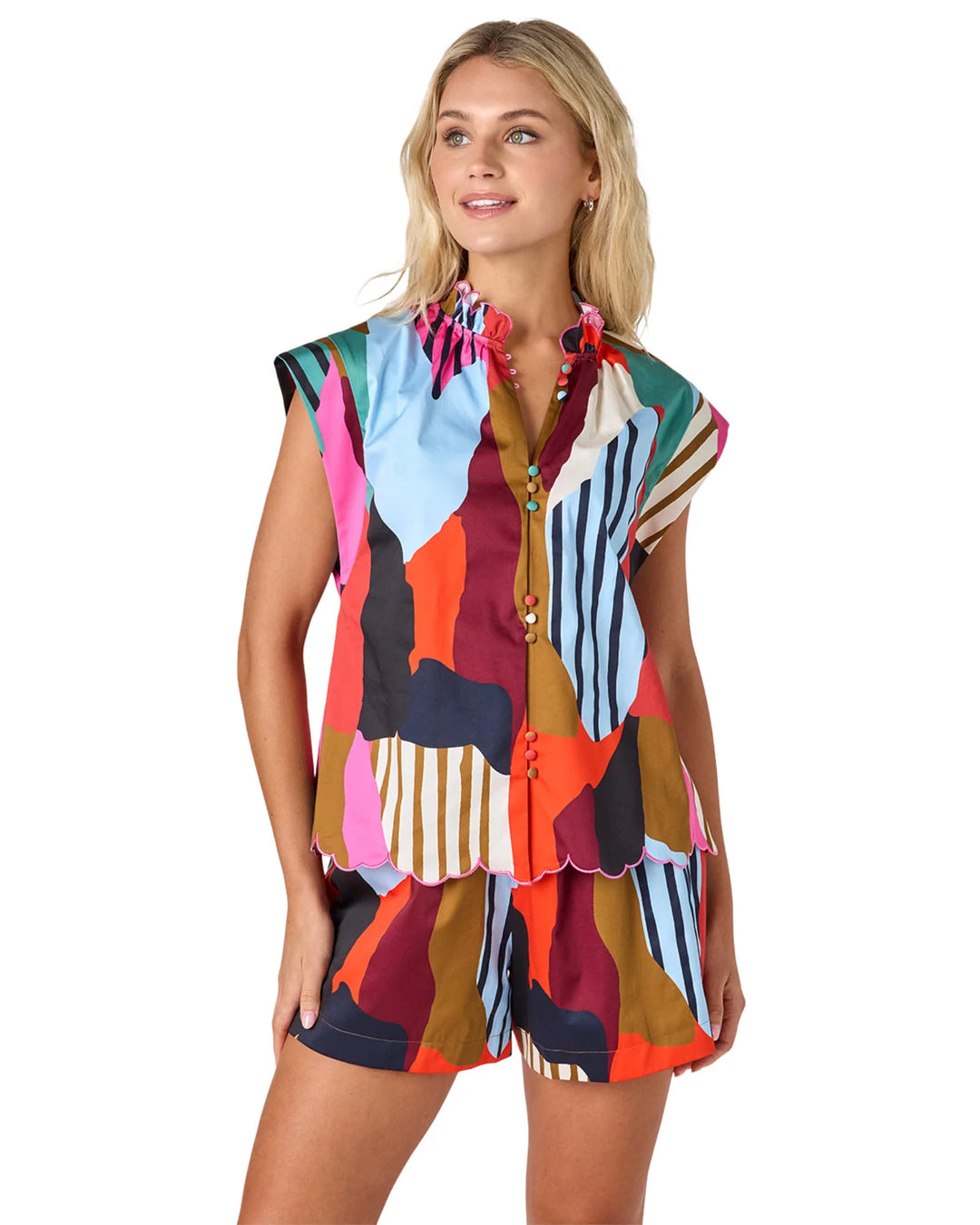 Crosby Fritzy Top in multicolor abstract color-block print, styled with a ruffle collar, cap sleeves, and full button front, shown against a white background.
