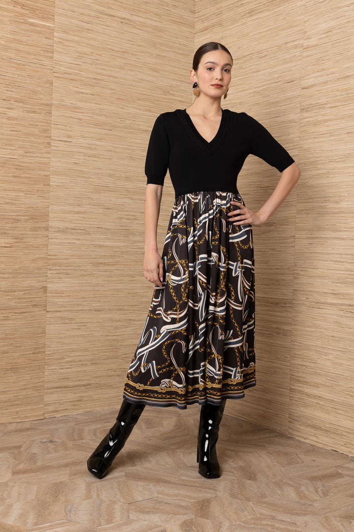 Hale Bob Landon Pleated Midi Dress in black with chain and ribbon print skirt — front view showing V-neckline and braided trim detail
