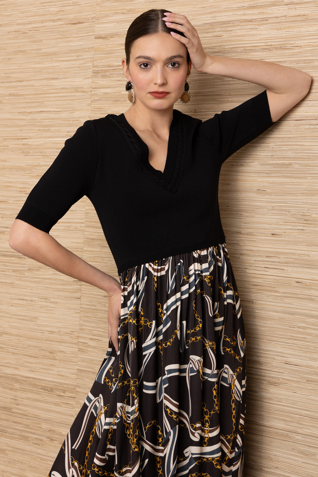 Hale Bob Landon Pleated Midi Dress in black with chain and ribbon print skirt — close-up front view showing neckline and sleeve detail