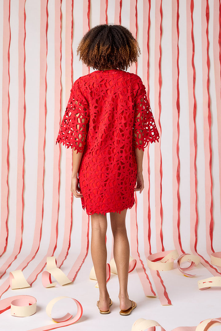 Back view of Crosby Alice Lace Tunic Dress in Pomegranate showing full geometric crochet lace construction, three-quarter bell sleeves with scalloped lace hem, and relaxed boxy tunic silhouette at mini length.