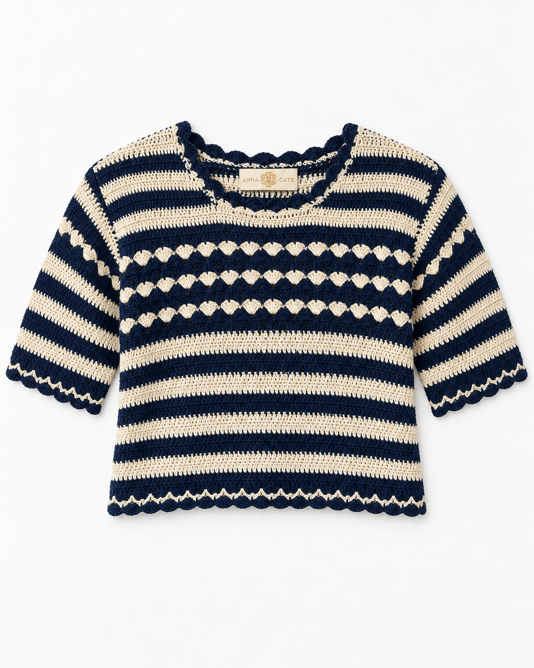 Flat lay of the Anna Cate crochet sweater in navy and cream stripes, featuring scalloped trim at the neckline, sleeves, and hem, with a shell-stitch textured band across the chest.