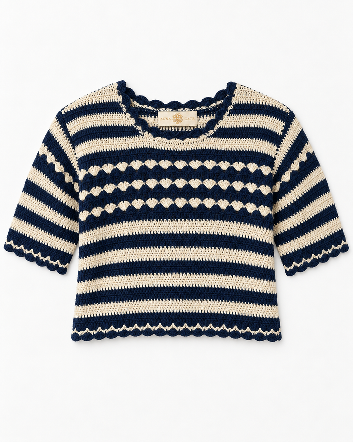 Flat lay of the Anna Cate crochet sweater in navy and cream stripes, featuring scalloped trim at the neckline, sleeves, and hem, with a shell-stitch textured band across the chest.