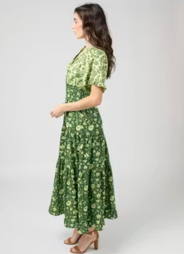 Beau &amp; Ro Anya Dress in Jaipur Green two-tone floral print, side view showing the tiered maxi skirt and flutter sleeve, worn with brown block-heel sandals.