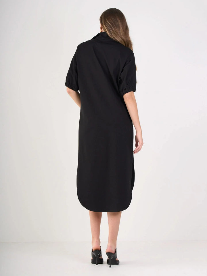 Back of Black ponte caftan with vegan leather tuxedo stripe detail, optional stand collar, and curved tail hem by Emily McCarthy.