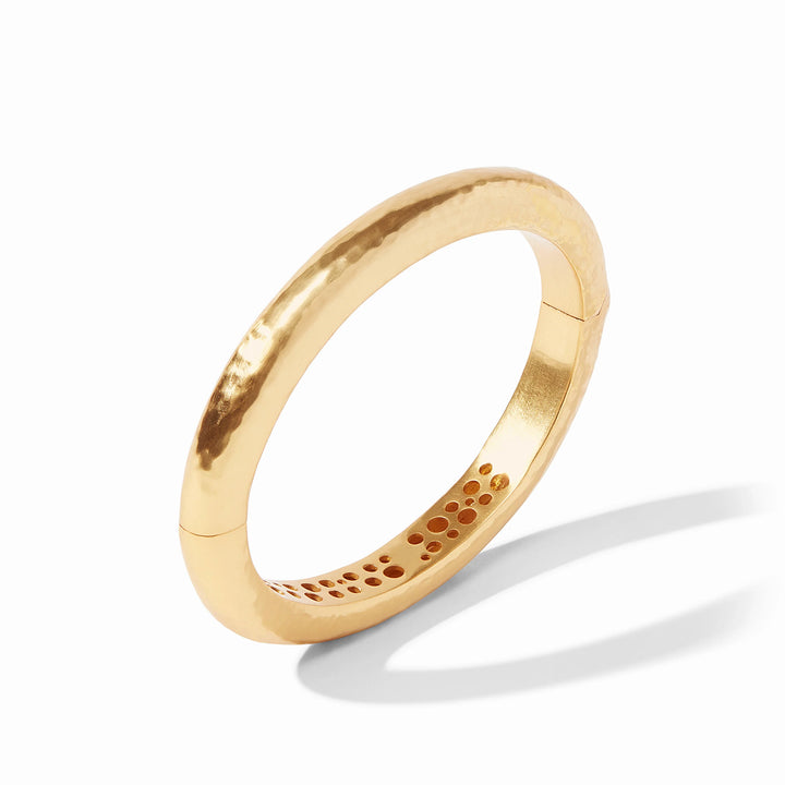 Julie Vos Catalina Hinge Bangle in 24K gold plate — smooth hammered oval band with engraved interior detailing and spring-hinge closure, shown standing upright on white background.