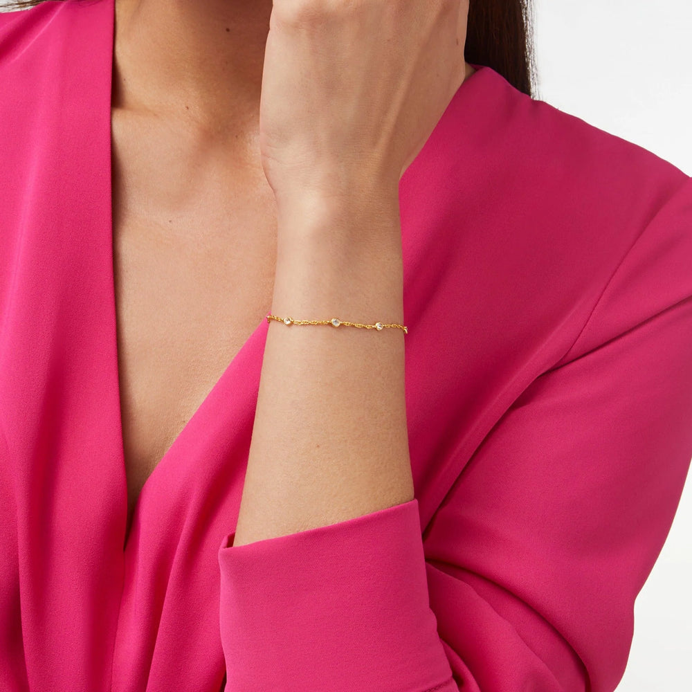 Julie Vos Celeste Delicate Bracelet worn on wrist, seven cubic zirconia stones along delicate 24K gold plate chain