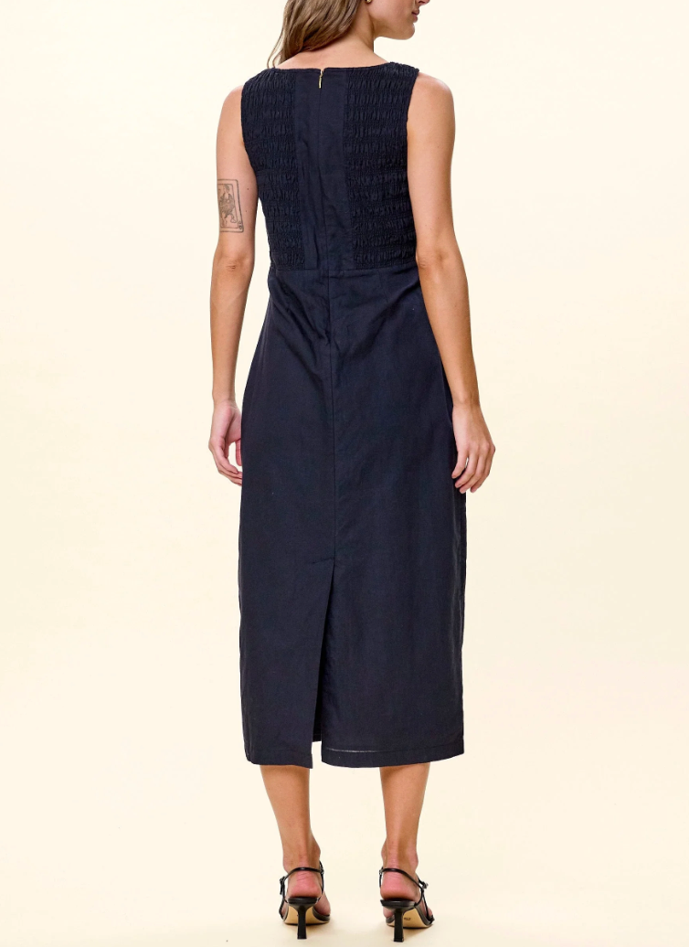 Cleobella Ruxandra Midi Dress in Black — back view on model showing smocked panel and hem slit
