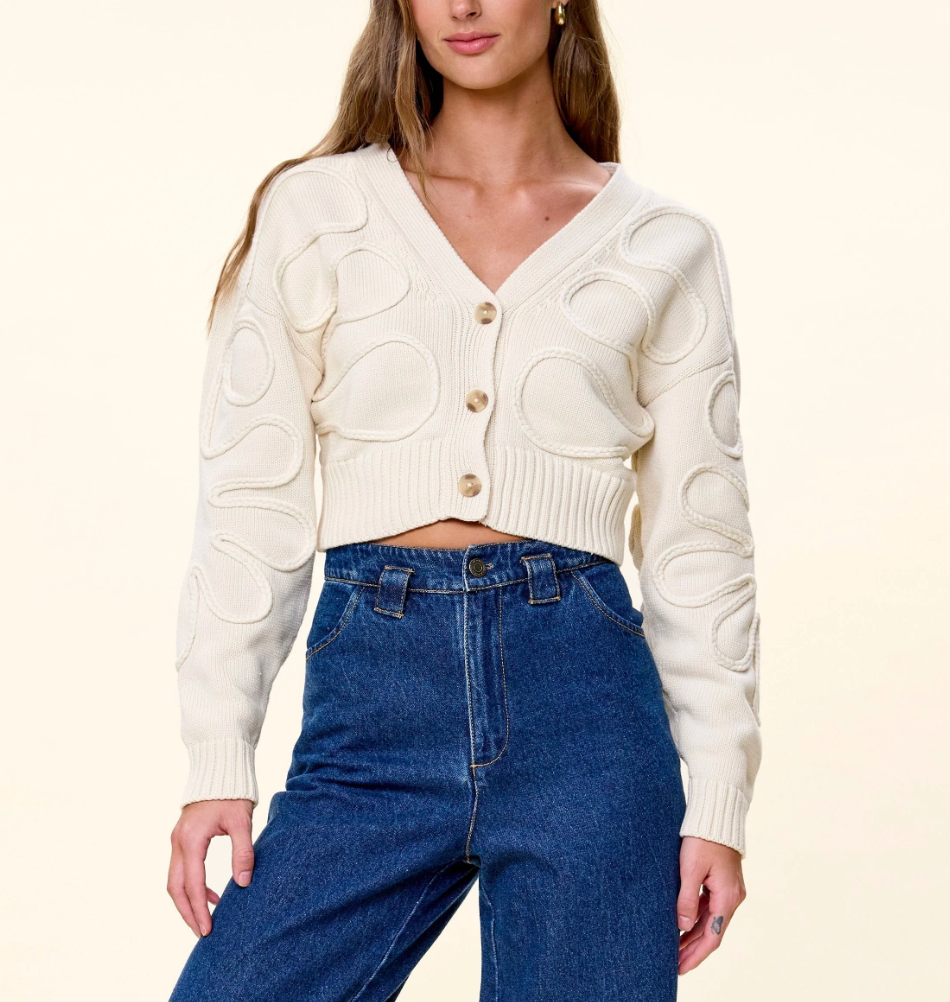 Cleobella The Cher Sweater in Ivory — front view on model, buttoned, styled with denim