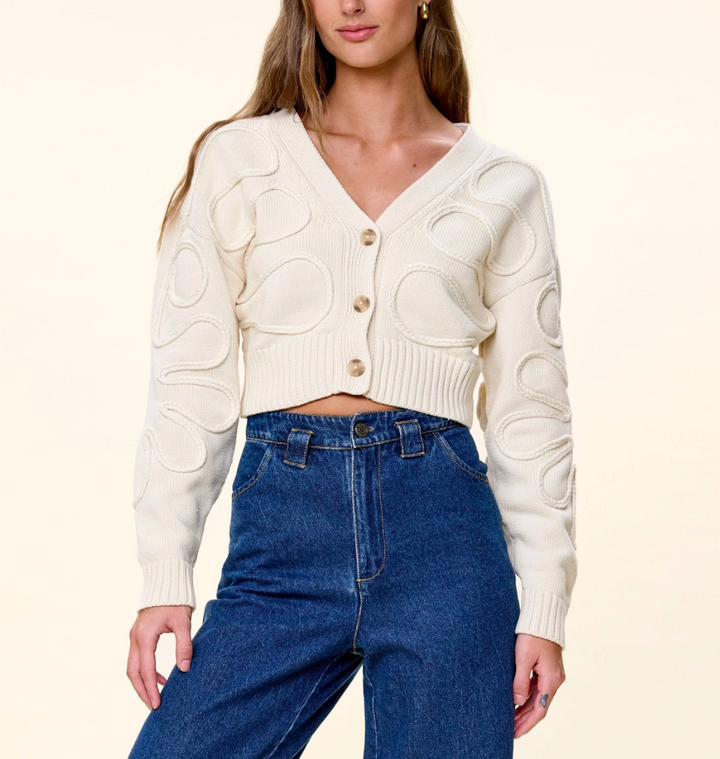 Cleobella The Cher Sweater in Ivory — front view on model, buttoned, styled with denim
