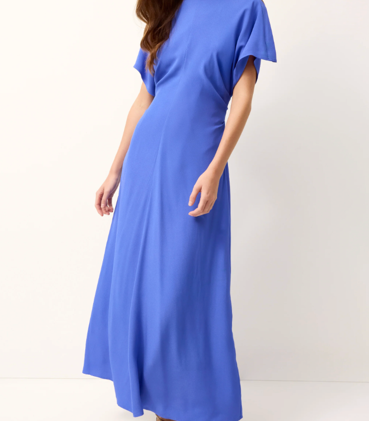 Woman wearing a blue dress against a white background