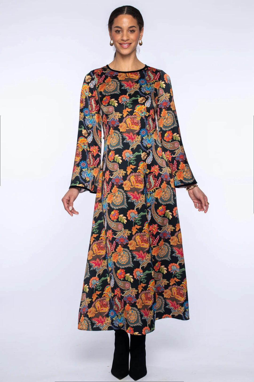 Model wearing the Elizabeth James Lily Long Dress in paisley without the belt, showing the tapered shape, round neckline, long bell sleeves, and slightly flared hem.