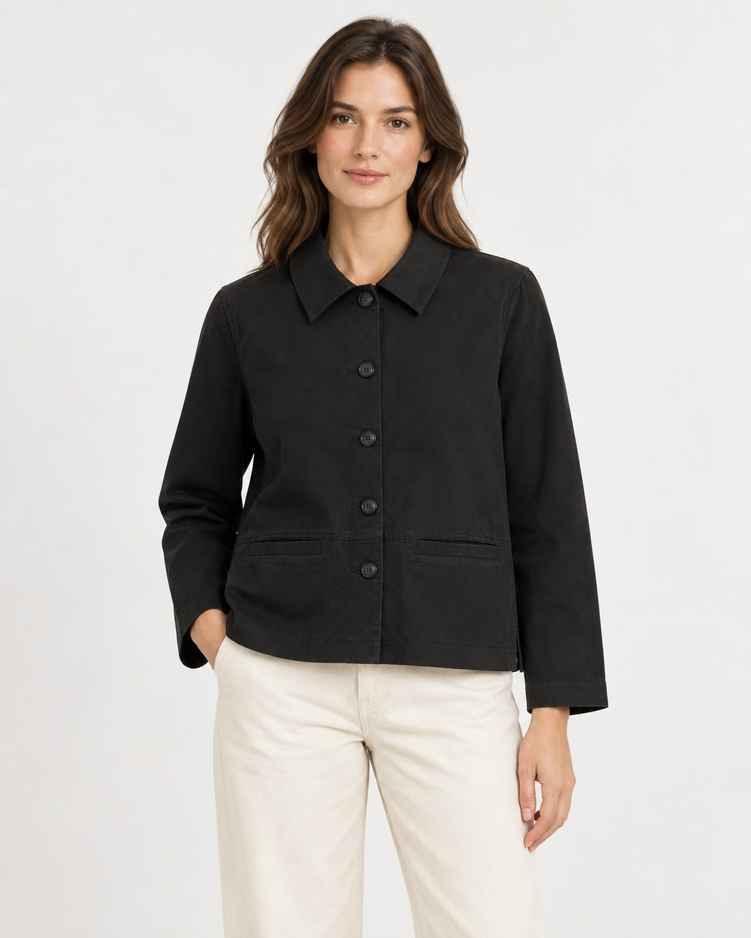 Elliott Lauren Easy Street Coat in Black, front view on model, showing a boxy hip-length utility jacket with point collar, five-button front, and two welt pockets, styled with cream wide-leg trousers