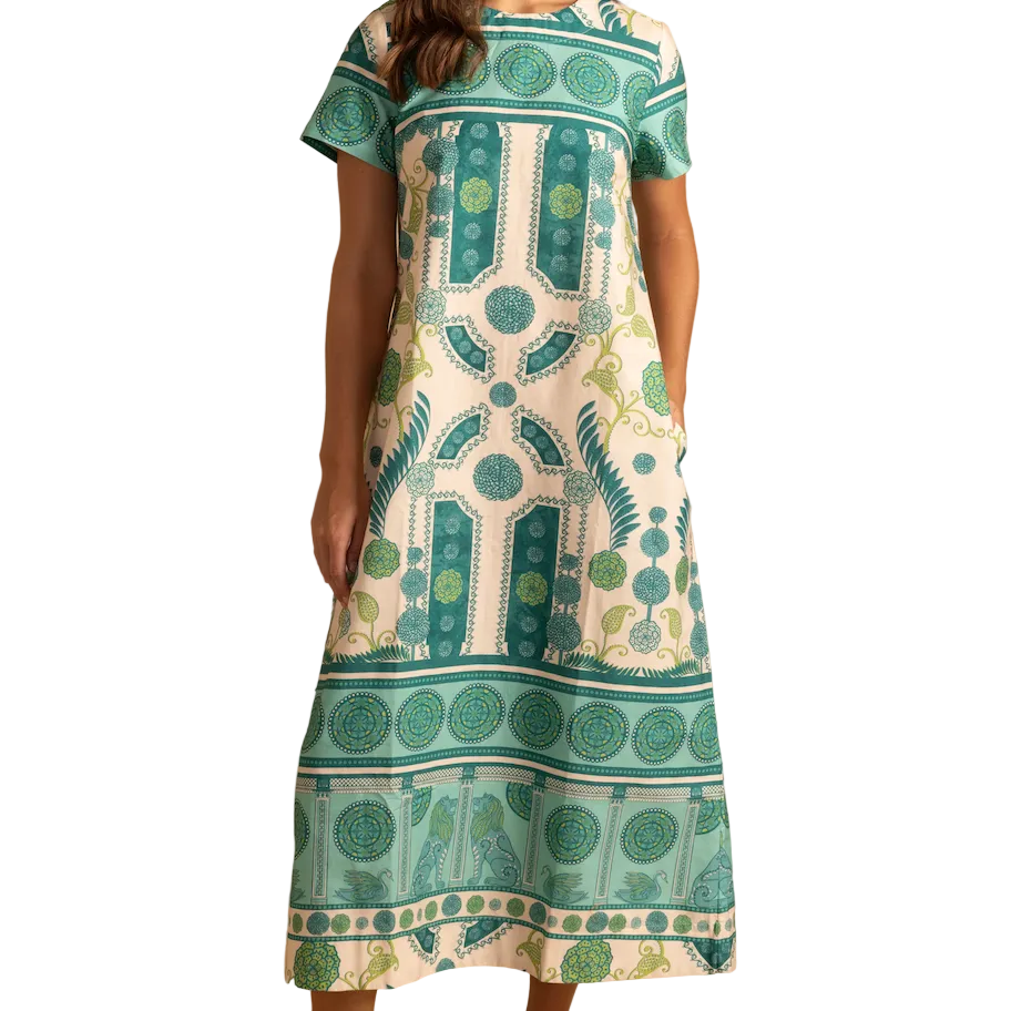 Woman wearing a patterned dress with a white background