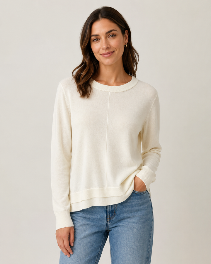Elliott Lauren Cream Double Hem Detail Sweater, front view, model wearing ivory crewneck sweater with center seam and double hem detail over light wash denim.