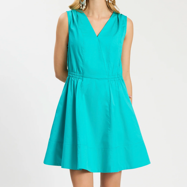 Teal dress worn by a person on a white background