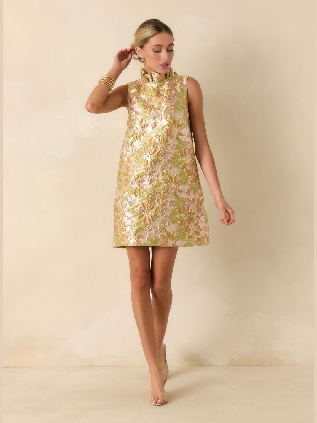 Prosperina Cecily Mini Dress in champagne metallic floral jacquard, sleeveless shift silhouette with ruffled mock neckline, shown on model facing forward - 2.