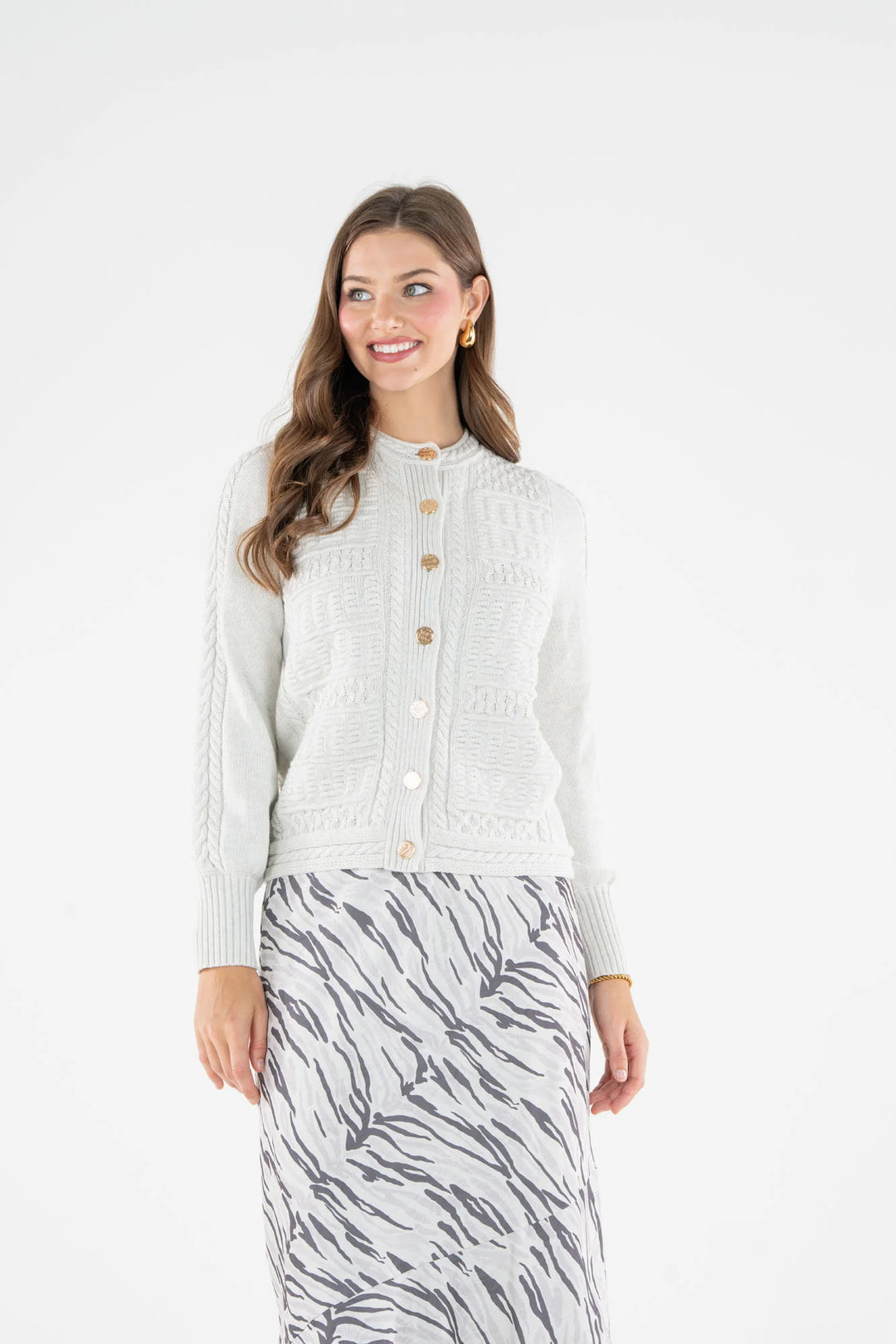 Emily McCarthy Chloe Cardigan in Carrara — front view, alternate angle showing button placket and cable knit