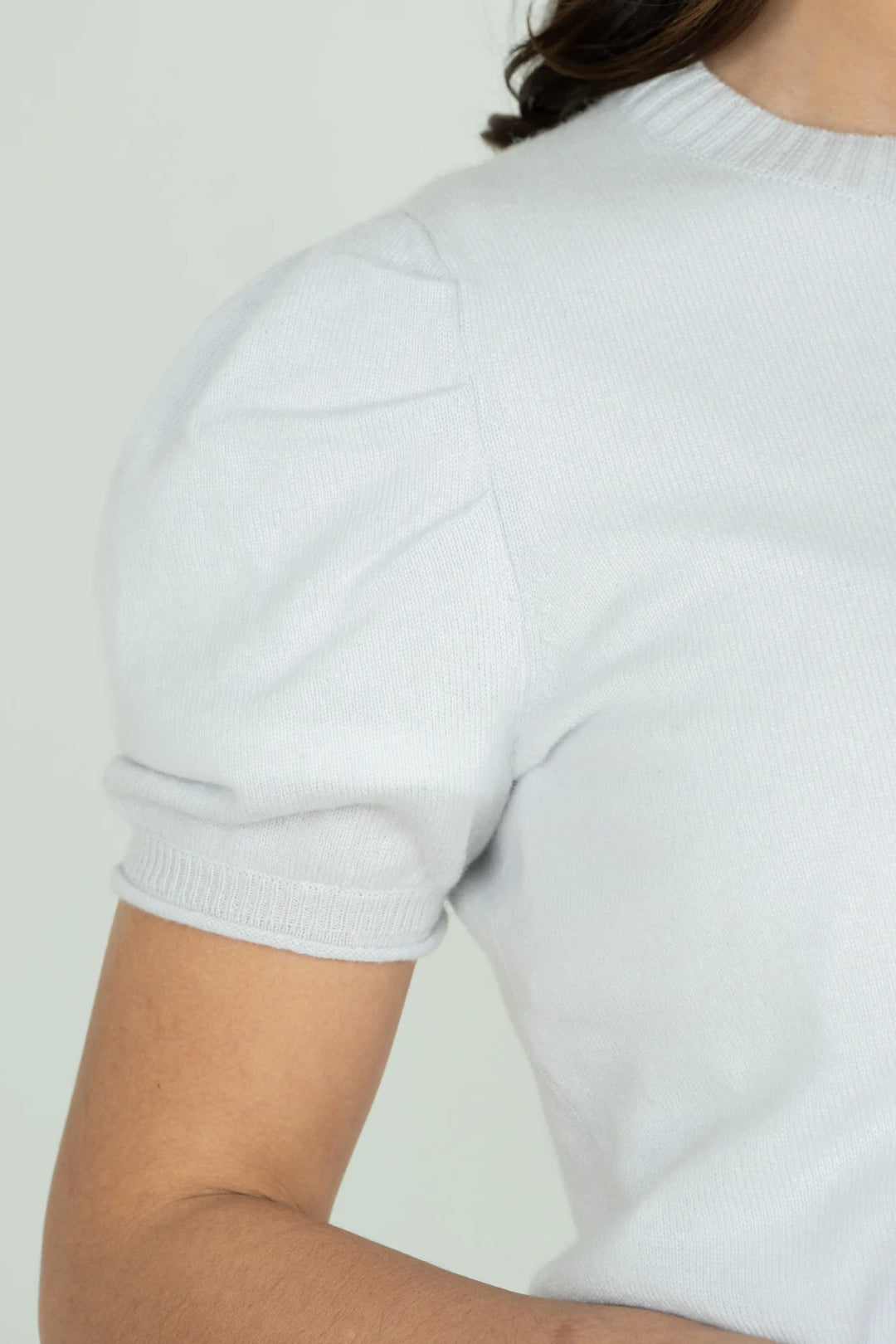 Emily McCarthy Barely Blue Crewneck Knit Sweater — detail view of puff sleeve and ribbed cuff and neckline