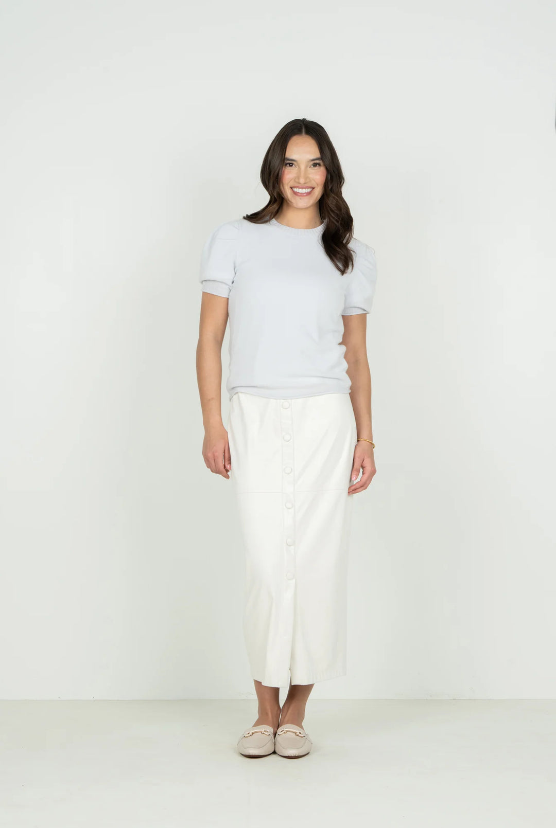Emily McCarthy Barely Blue Crewneck Knit Sweater — front view styled with white button-front midi skirt
