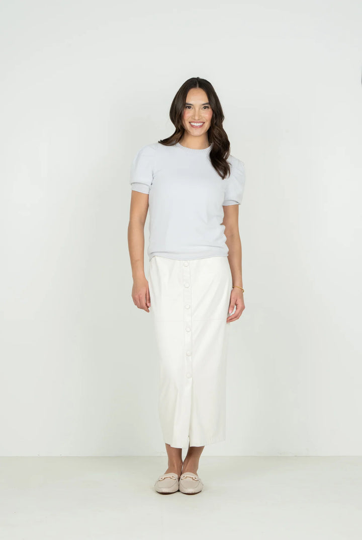 Emily McCarthy Barely Blue Crewneck Knit Sweater — front view styled with white button-front midi skirt