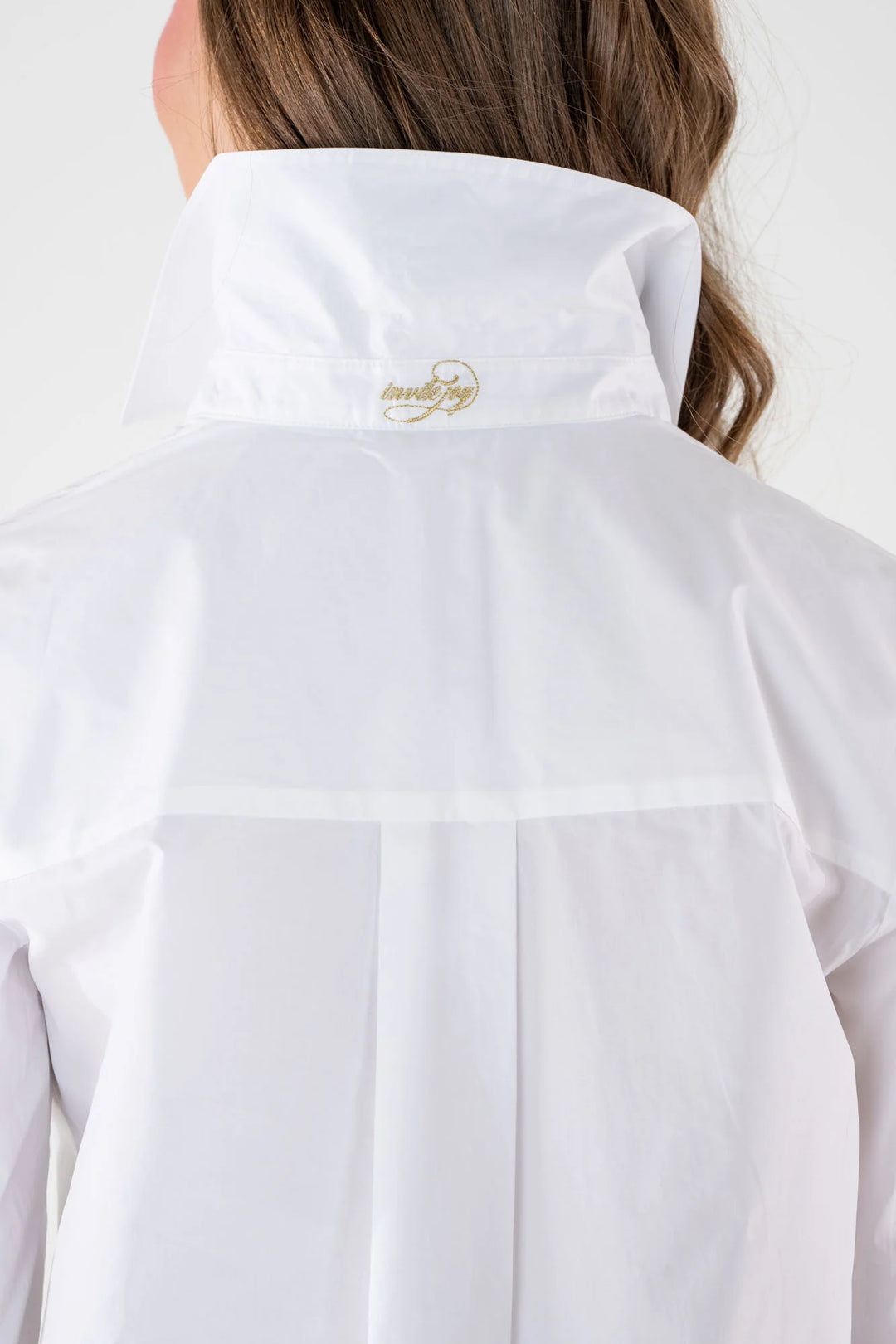 Emily McCarthy Classic Oxford Top in White — back on-model, showing back yoke and embroidered neck label