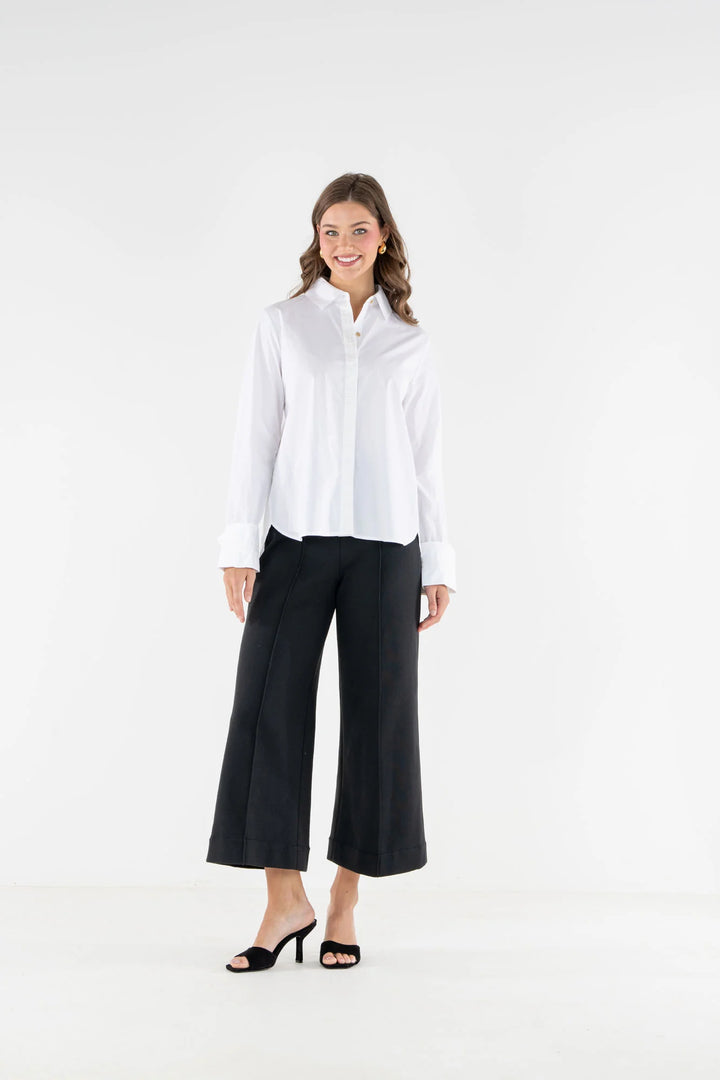 Emily McCarthy Classic Oxford Top in White — front on-model, styled with black wide-leg cropped trousers 2