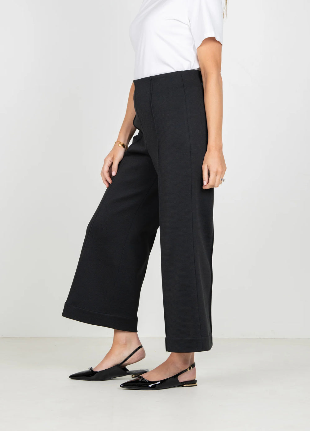 Emily McCarthy Cropped Piper Pant in Black — side profile on-model, showing high-rise waist and flare