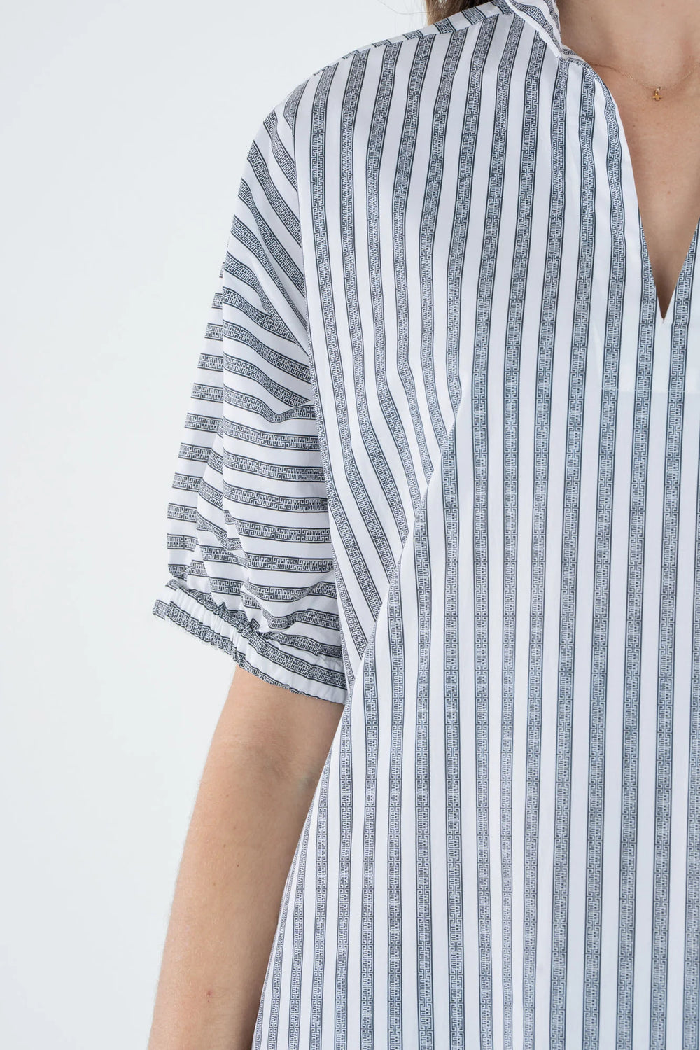 Emily McCarthy Poppy Maxi Dress in Black Stripe — detail close-up of collar, sleeve, and monogram stripe pattern