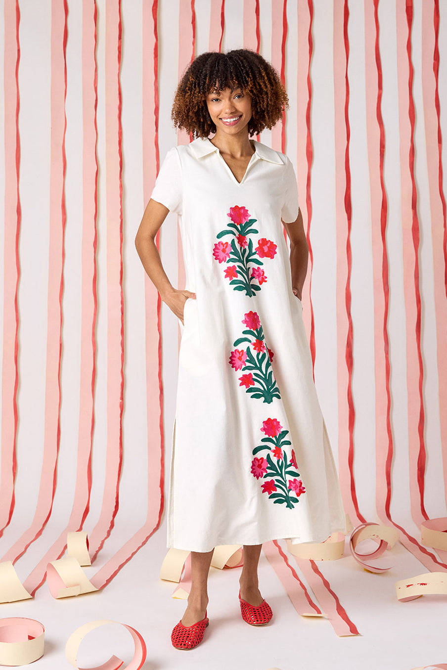 Crosby Franny Embroidered Maxi Dress in ivory with asymmetric floral embroidery featuring coral blooms and green stems, polo-style open collar, and short sleeves.