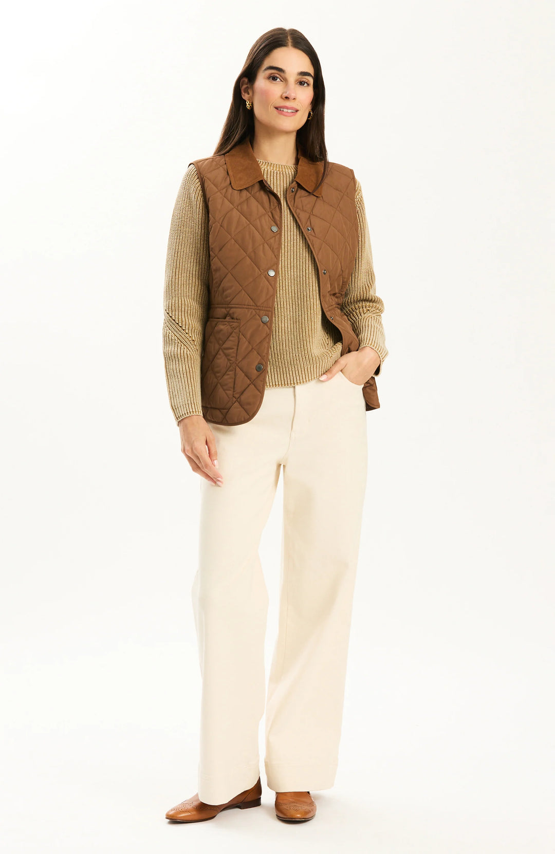 Tyler Boe Amoreena Quilted Vest in Bison, front view on-model layered over ribbed knit sweater, full-length