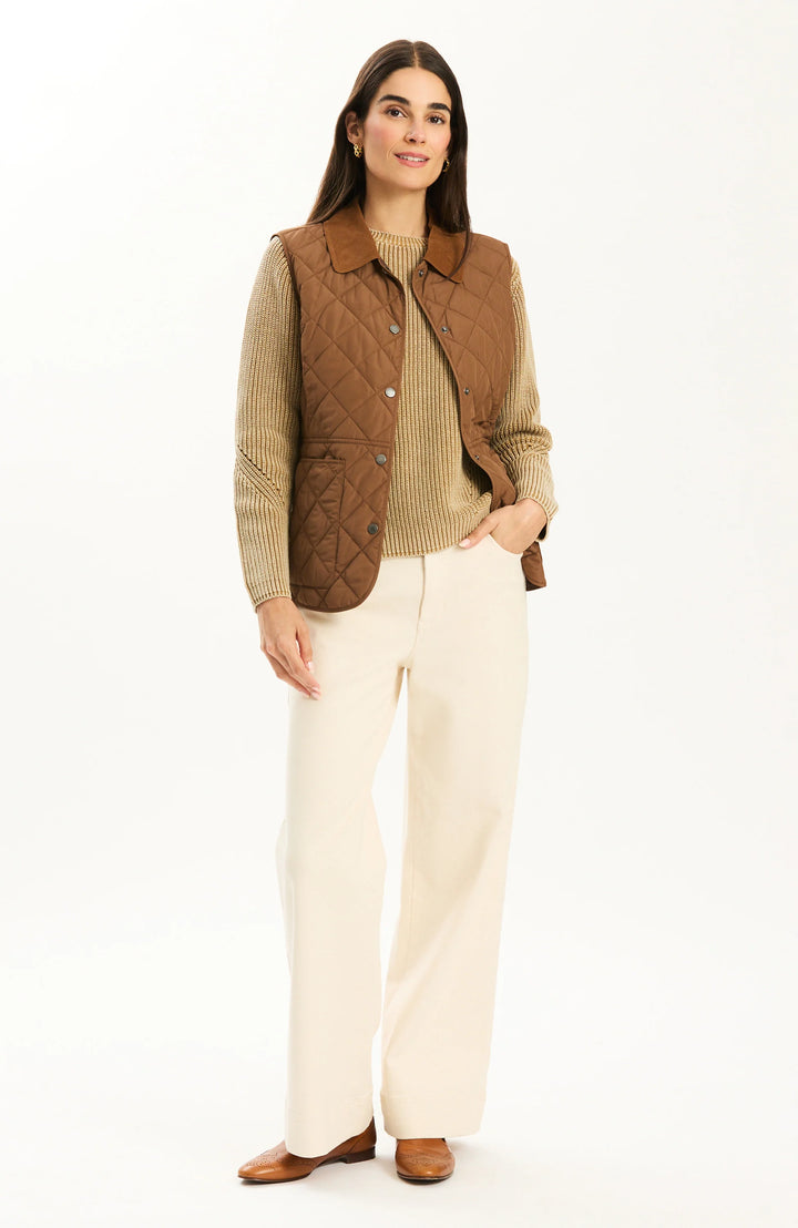 Tyler Boe Amoreena Quilted Vest in Bison, front view on-model layered over ribbed knit sweater, full-length