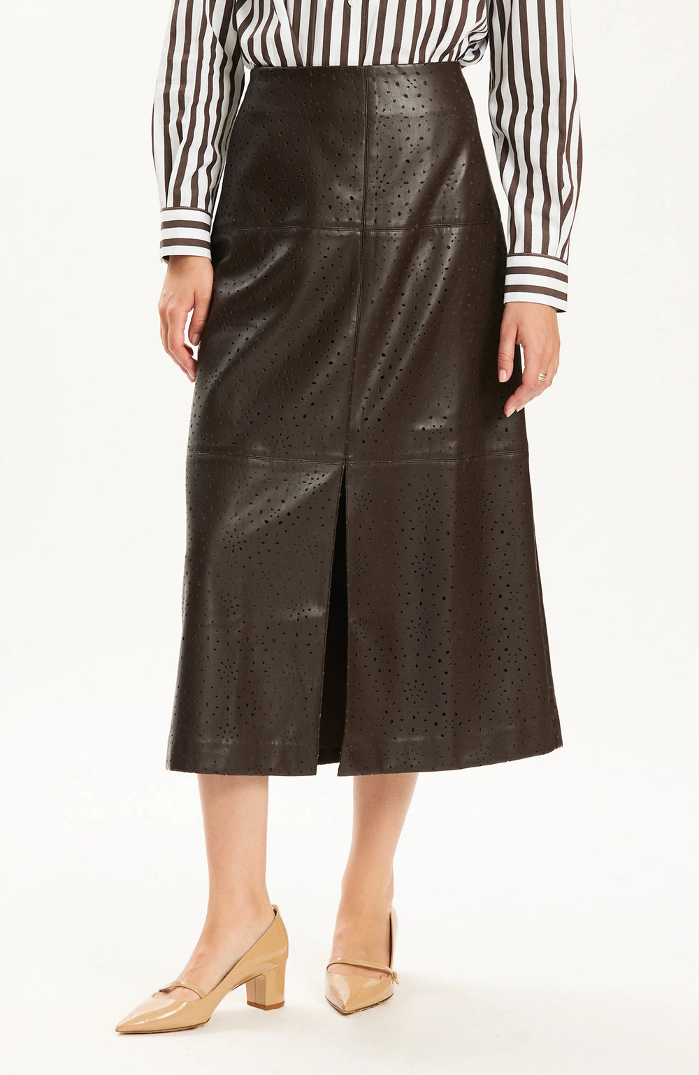 Close-up front view of the perforated texture and front slit on the dark brown vegan leather skirt.