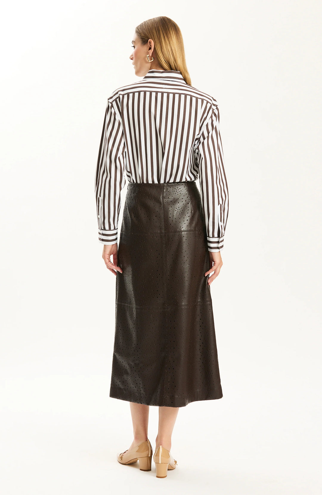 Back view of the A-line skirt silhouette with striped shirt tucked at the waist.