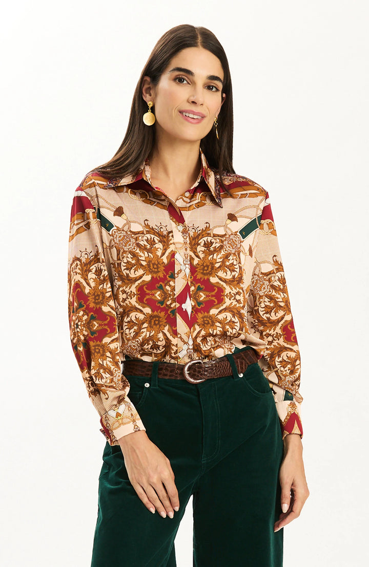 Tyler Boe Chloe Status Charmeuse Blouse, front view on model tucked into dark green corduroy trousers with a brown croc-embossed belt, showing buttoned cuffs and satin sheen