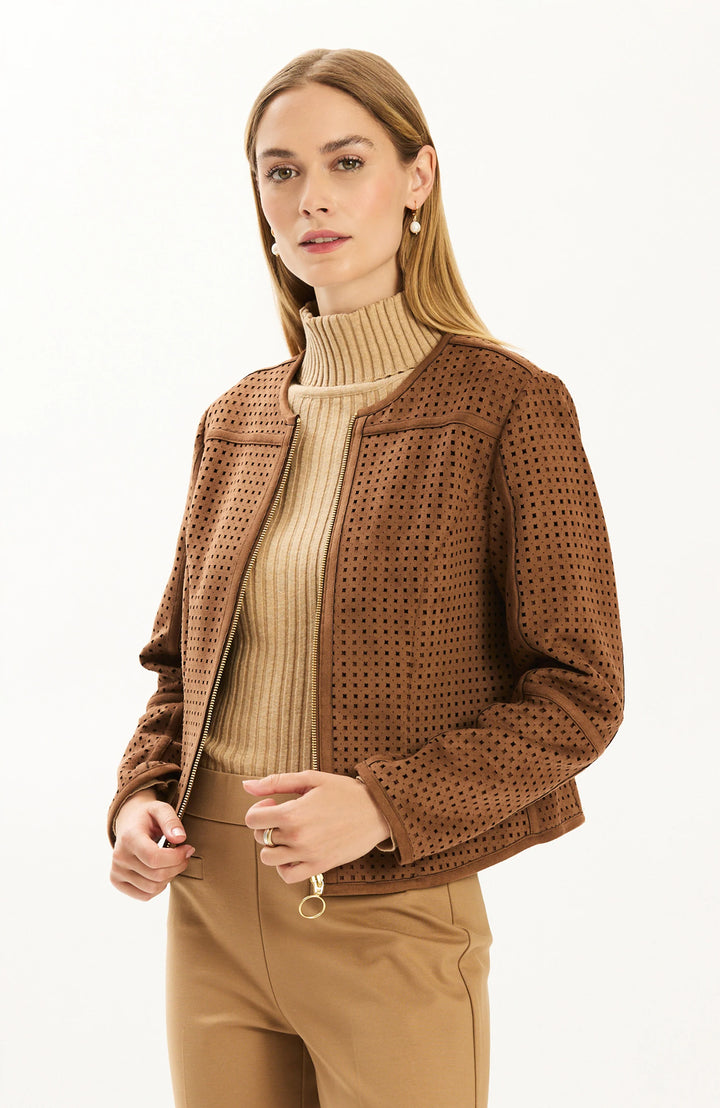 Front view, model in tan ribbed turtleneck and camel trousers wearing an open brown punched faux suede jacket with gold zipper.