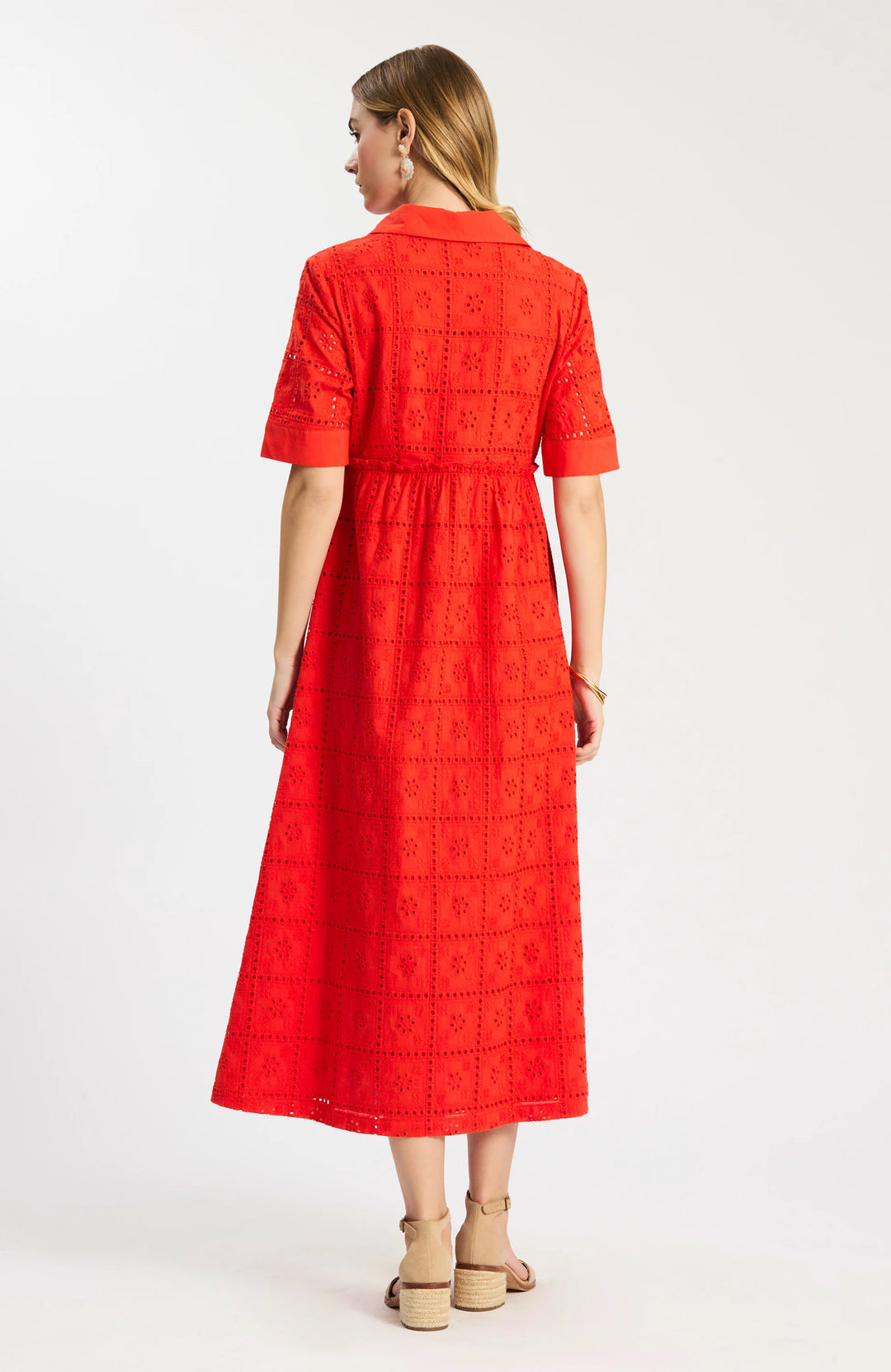 Model wearing Tyler Boe Lane Eyelet Maxi Dress in grenadine, full-length front view, styled with tan block-heel sandals and floral earrings, on white background. - backside