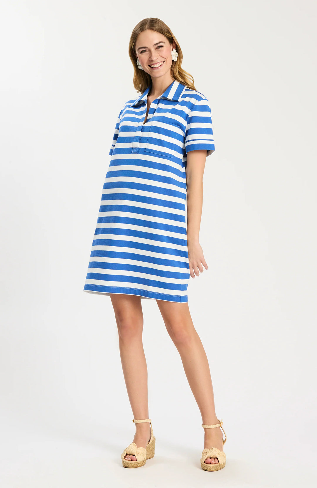 Tyler Boe Toni Knit Striped Polo Dress in blue and white stripe, shown front on-model, point collar with concealed button placket, short cuffed sleeves, patch chest pocket, relaxed shift silhouette falling above the knee.