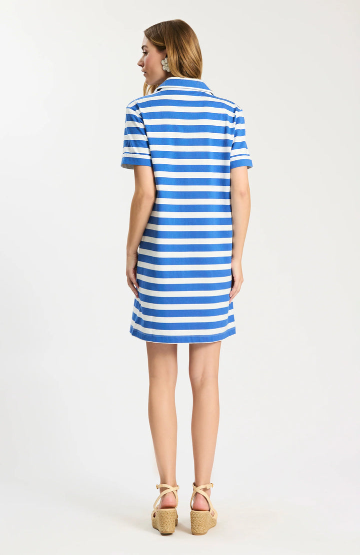 Back of Tyler Boe Toni Knit Striped Polo Dress in blue and white stripe, shown front on-model, point collar with concealed button placket, short cuffed sleeves, patch chest pocket, relaxed shift silhouette falling above the knee.