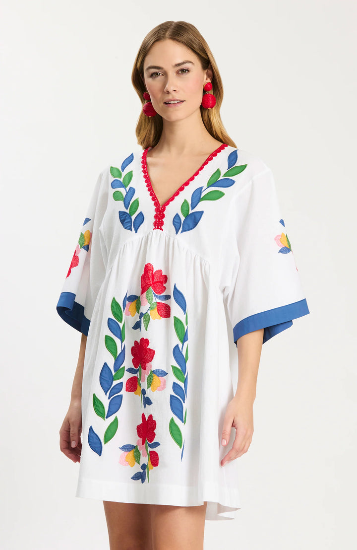 Tyler Boe Naomi Applique Dress, close-up of the V-neckline with red scalloped picot trim and the multicolor floral and leaf applique embroidery climbing the center front.