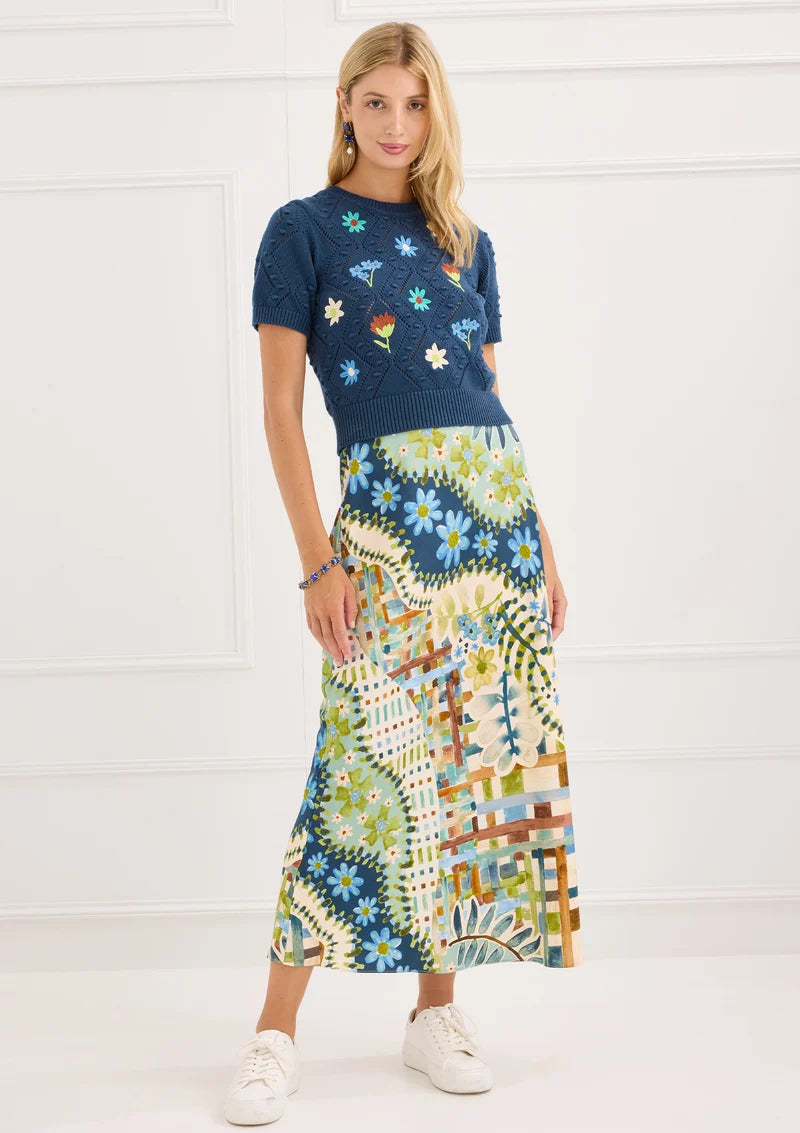 Alivia The Hillary Skirt in Mosaic Meadow, front view on-model styled with Nora Sweater in Navy, full-length