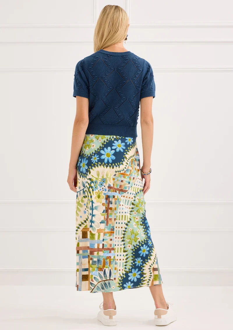 Alivia The Hillary Skirt in Mosaic Meadow, back view on-model styled with Nora Sweater in Navy, full-length