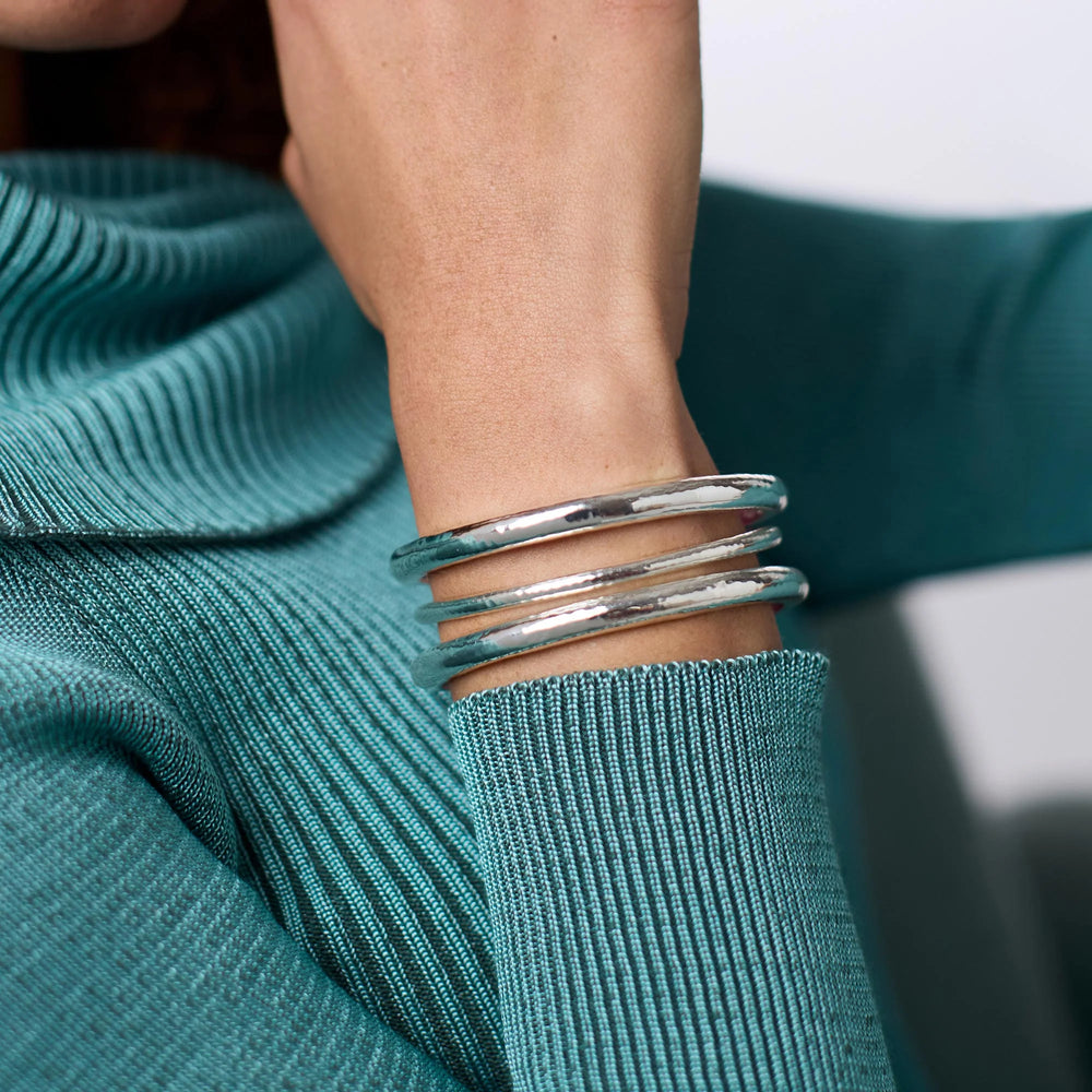Julie Vos Havana Demi Bangle in silver plate with hammered exterior and engraved geometric interior detail on model.